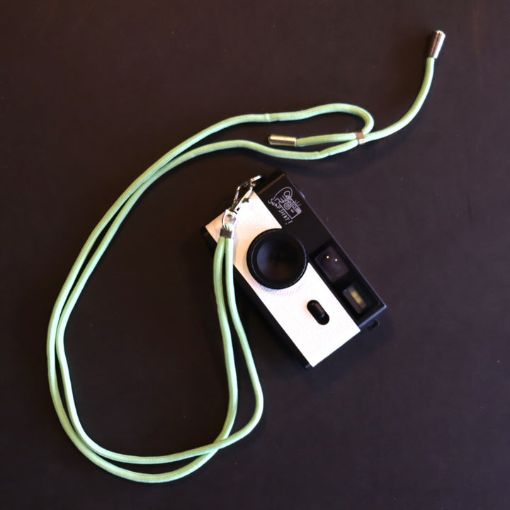 SNPSHT over the shoulder camera strap in orange